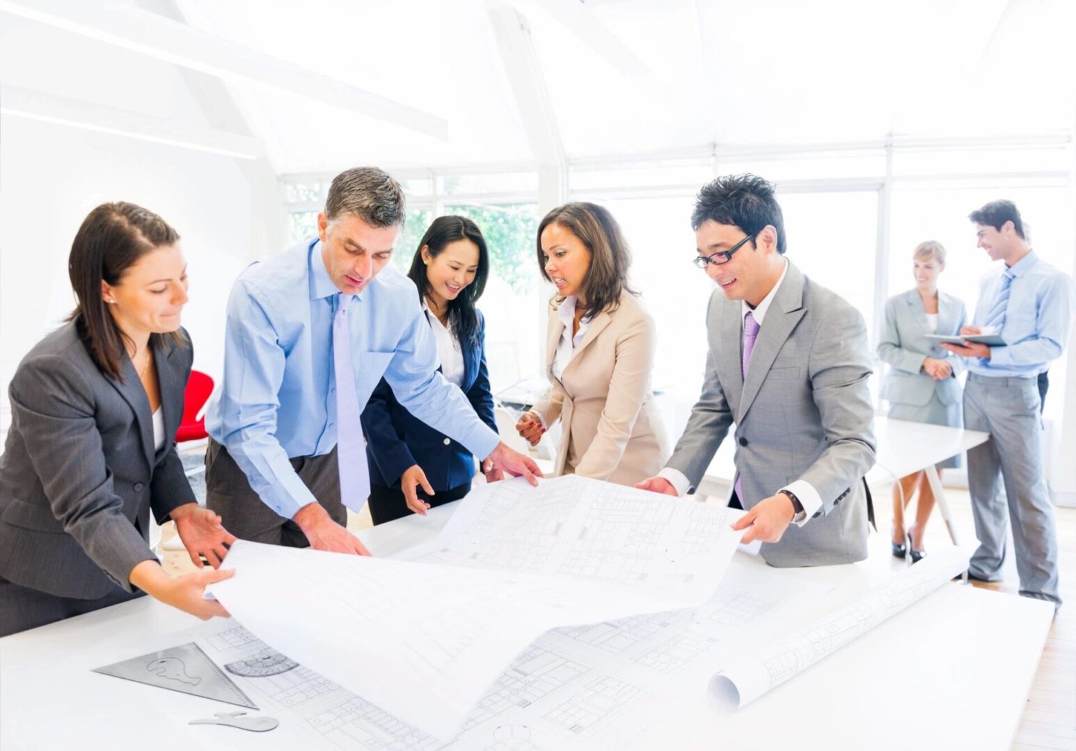 A group of people standing around a table.